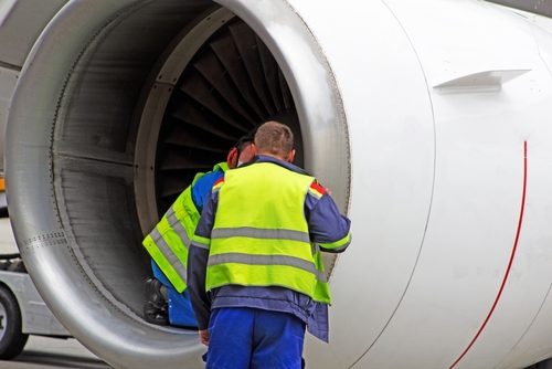 Mechanics working on an aircraft — VeriSpine Joint Centers helps injured employees recover through airport workers’ comp treatment services.